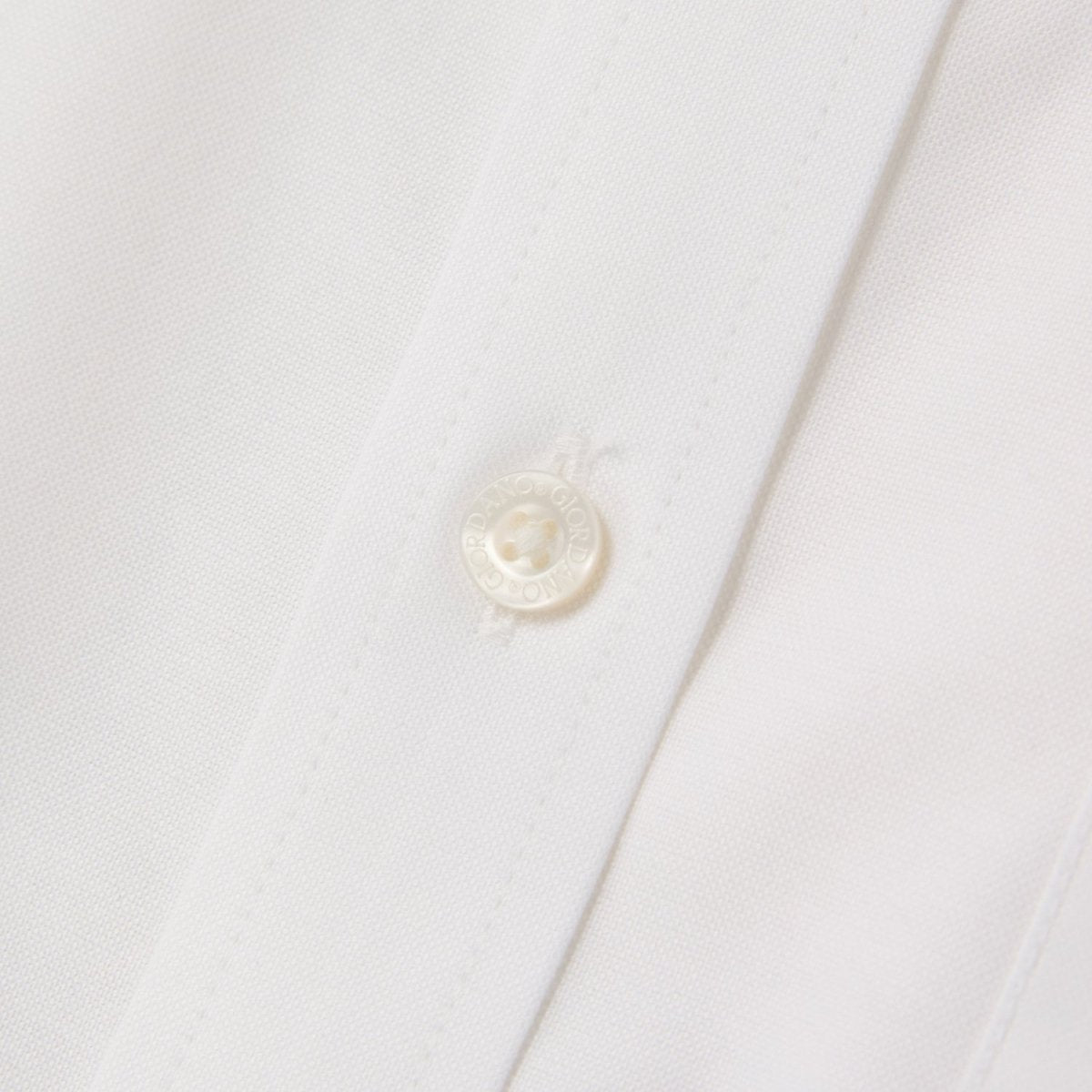 Giordano white wrinkle free cotton shirt for men close-up showing button and fabric texture