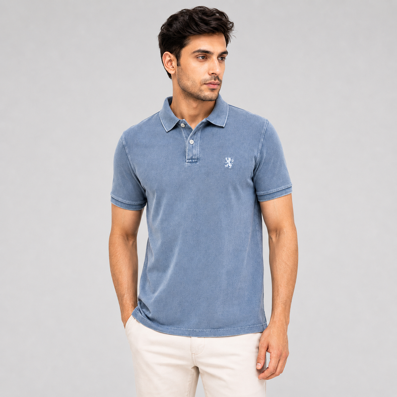 Man wearing a blue polo shirt with a logo on a gray background