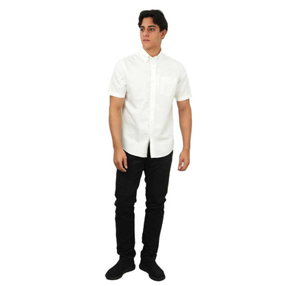 Giordano men's wrinkle-free oxford shirt in white worn with black pants and black shoes
